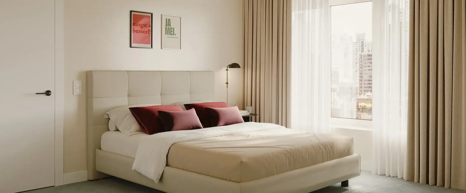 a bed with a lamp and a window