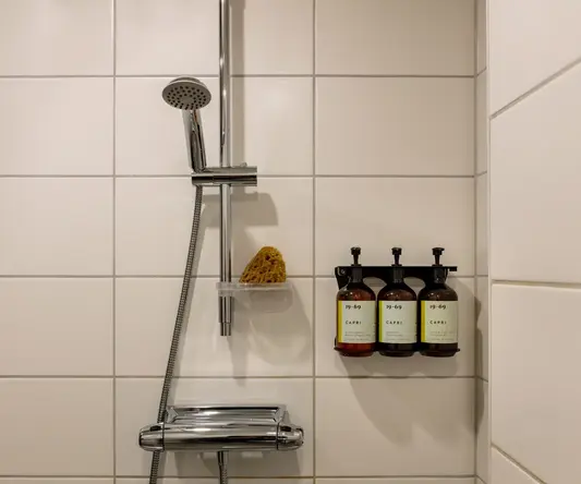 a shower head with soap and soaps
