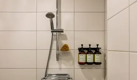 a shower head with soap and soaps