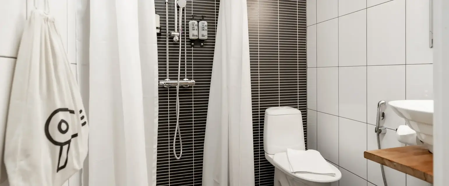 a bathroom with a toilet and shower
