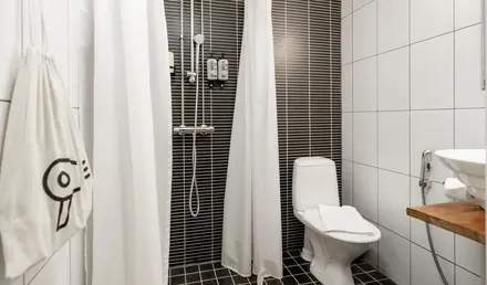 a bathroom with a toilet and shower