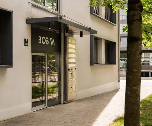 a building with a tree and a sign