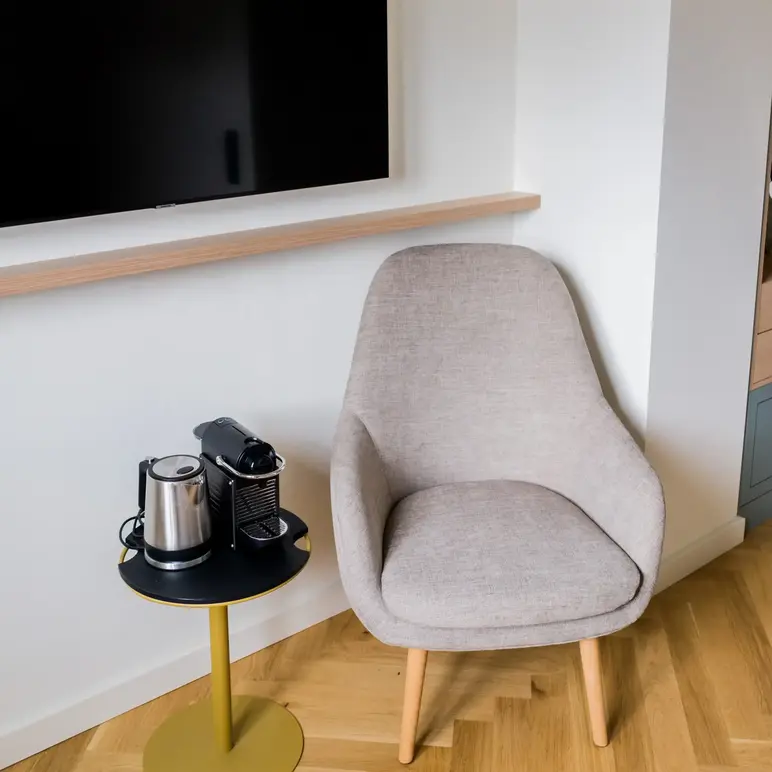 a chair and coffee cups on a table
