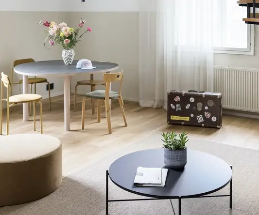 a room with a round table and chairs