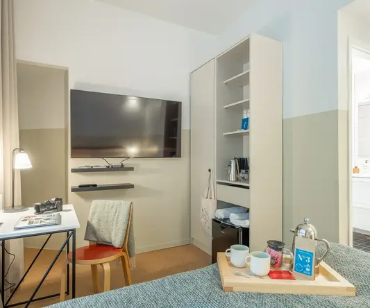 a room with a tv and a bed