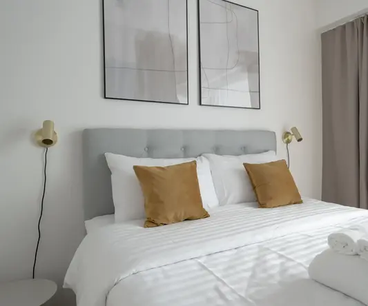 a bed with pillows and towels on it