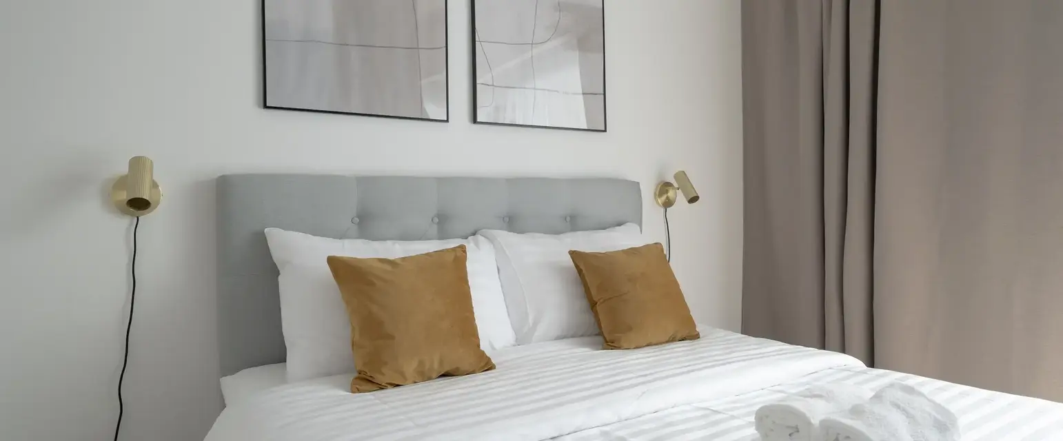 a bed with pillows and towels on it