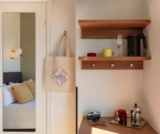 a coffee maker and coffee pot on a shelf