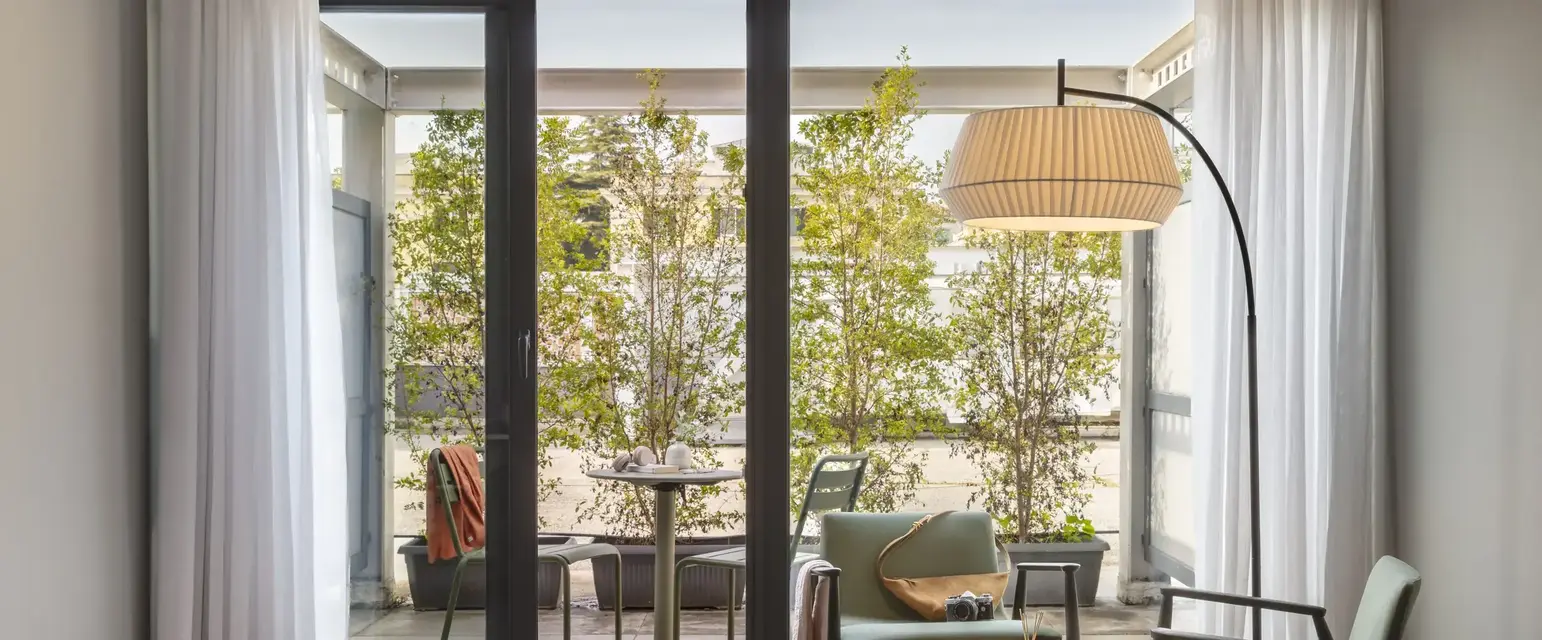 a room with glass doors and a table and chairs