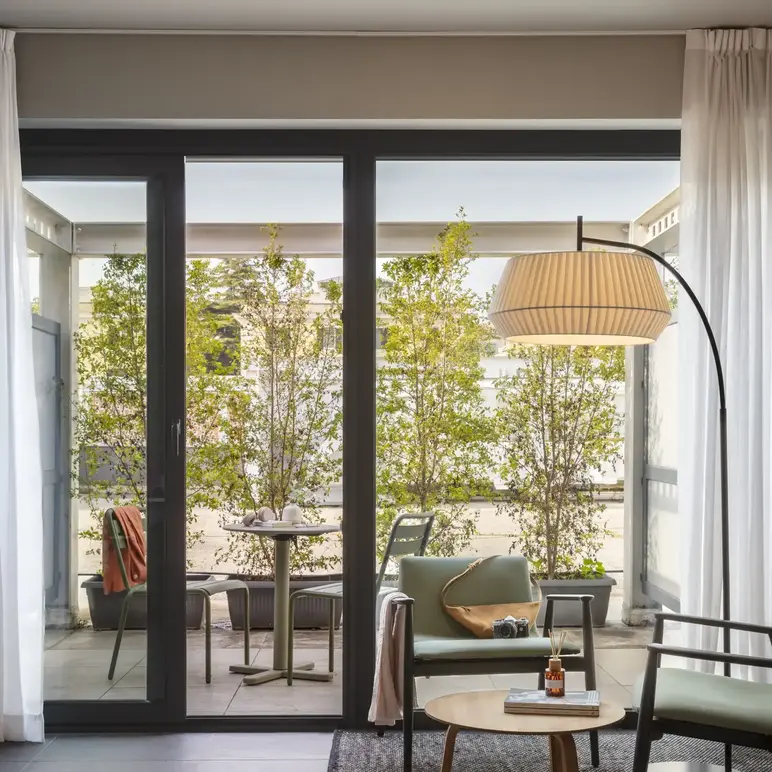 a room with glass doors and a table and chairs