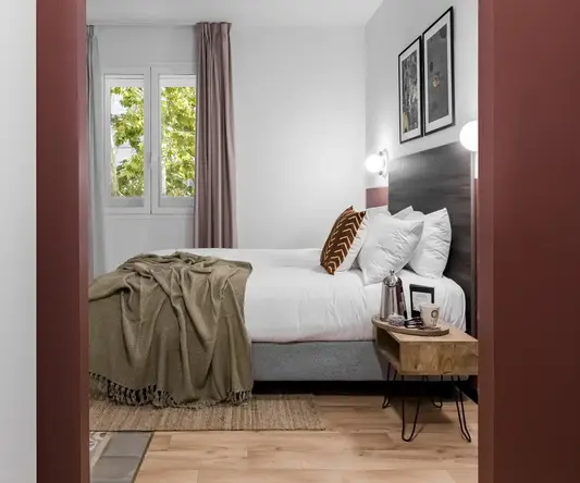 a bedroom with a bed and a table