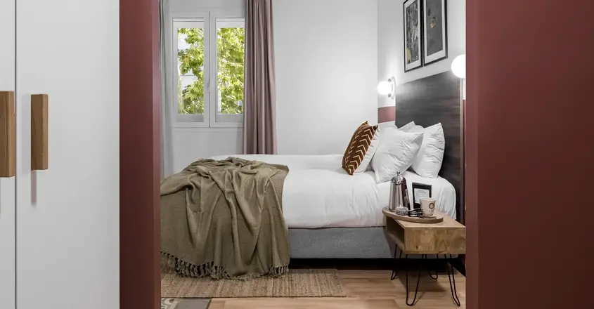 a bedroom with a bed and a table