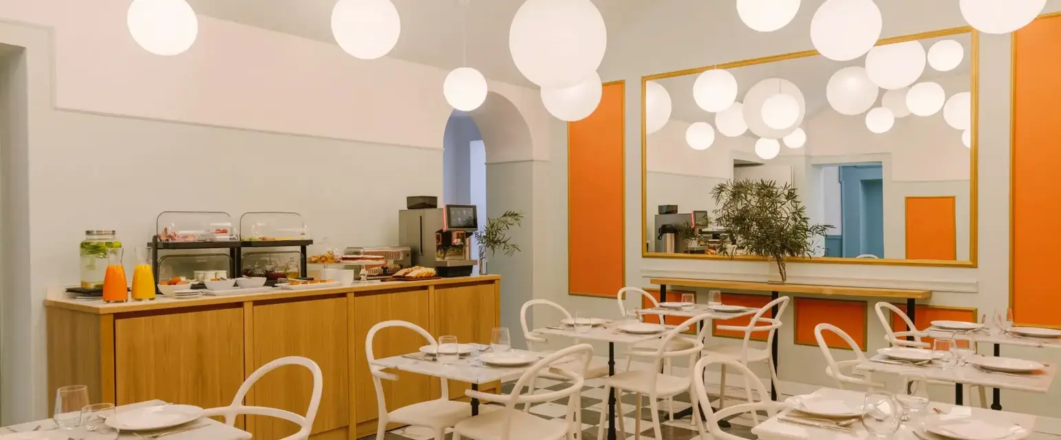 a room with tables and chairs and a mirror