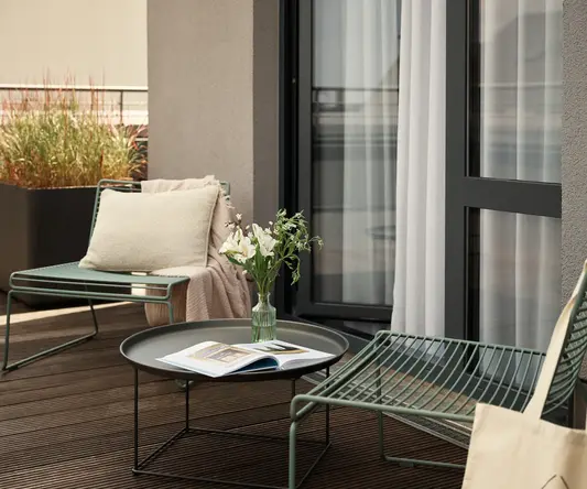 a patio with chairs and a table