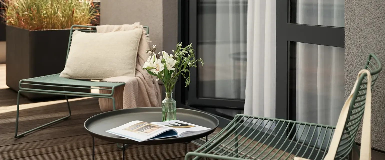 a patio with chairs and a table