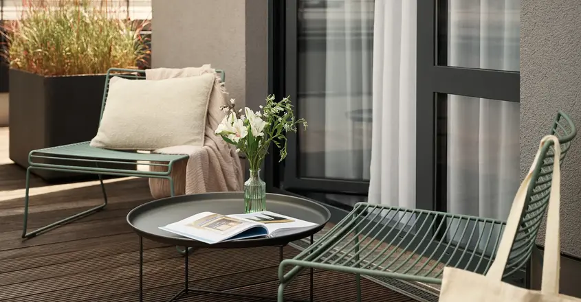 a patio with chairs and a table