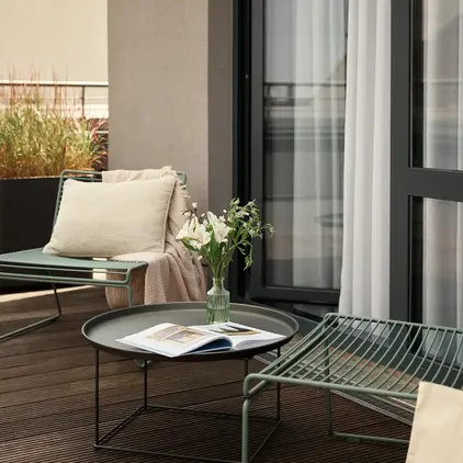 a patio with chairs and a table