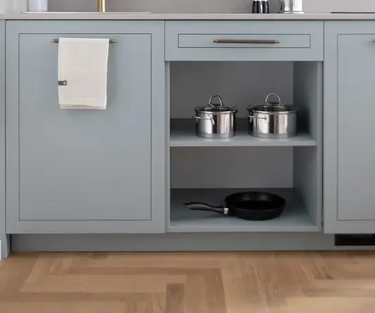 a kitchen with a microwave and pans