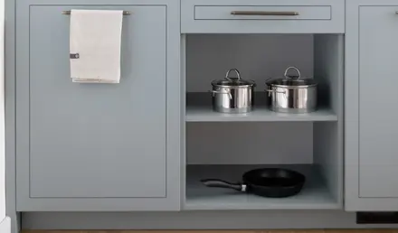 a kitchen with a microwave and pans