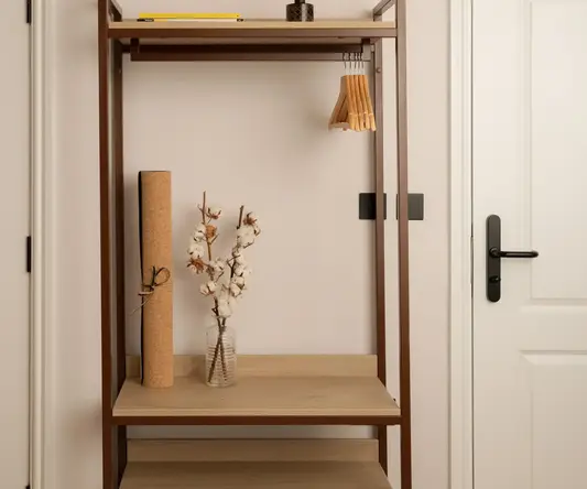 a shelf with a vase and a plant on it