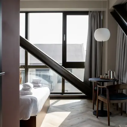 a room with a bed and chairs and a table