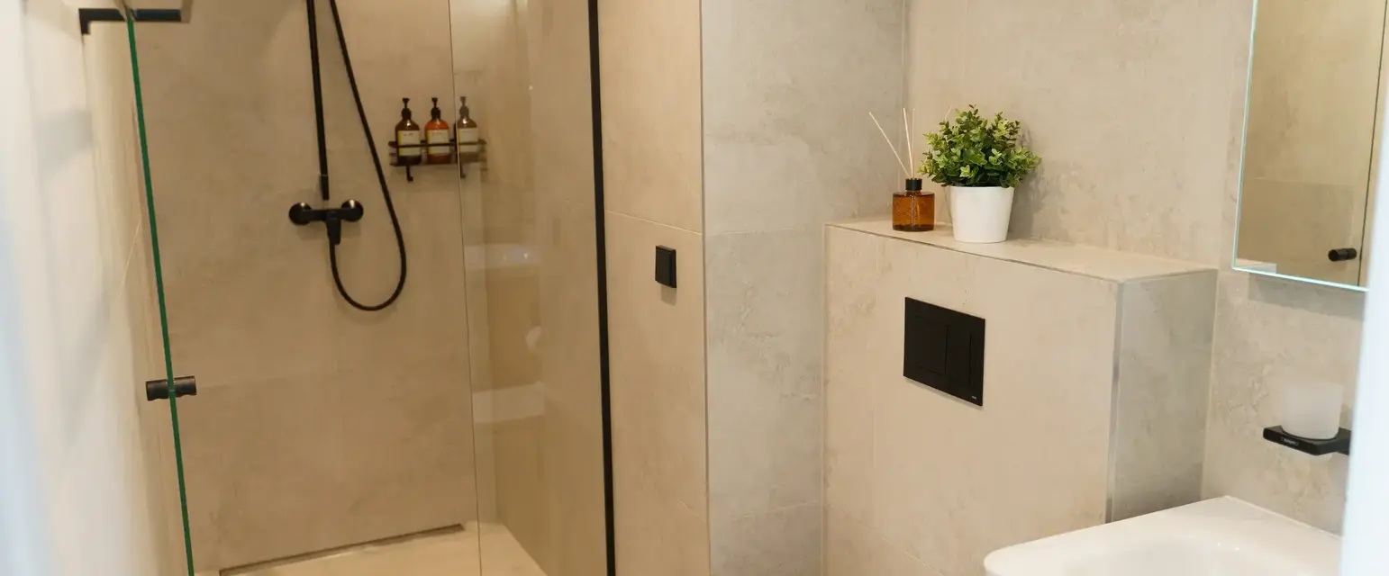 a bathroom with a glass shower and toilet