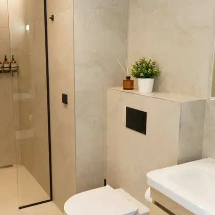 a bathroom with a glass shower and toilet