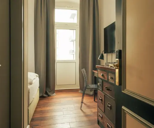 a room with a dresser and a chair