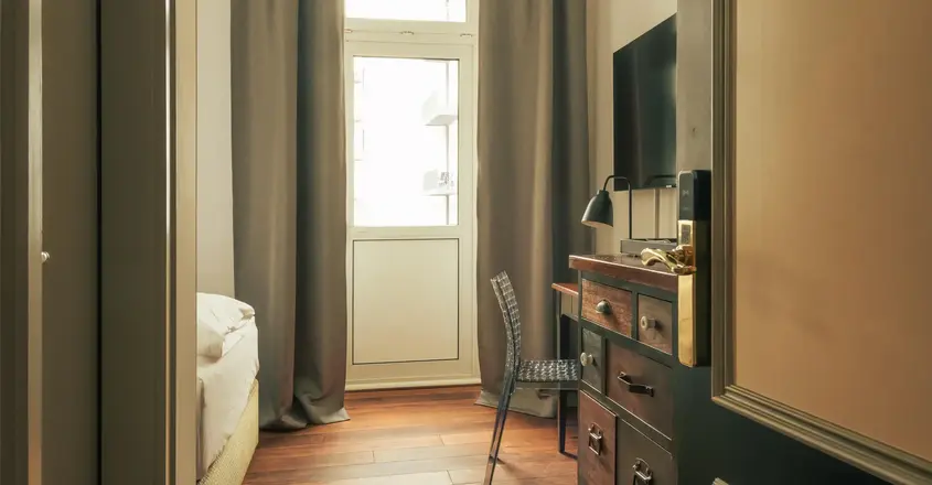 a room with a dresser and a chair