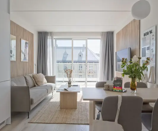 a living room with a table and chairs