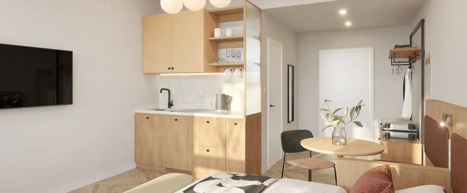 a bedroom with a kitchen and dining area