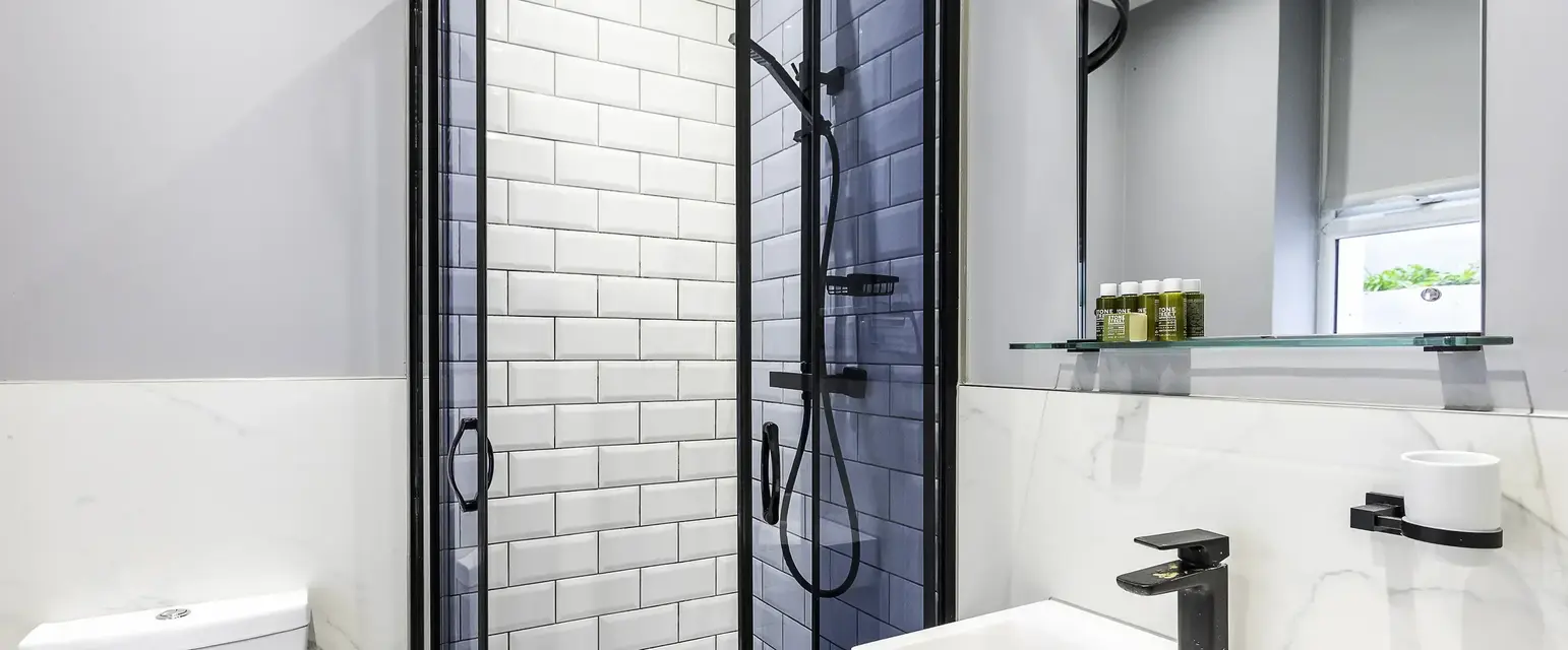 a bathroom with a shower and sink