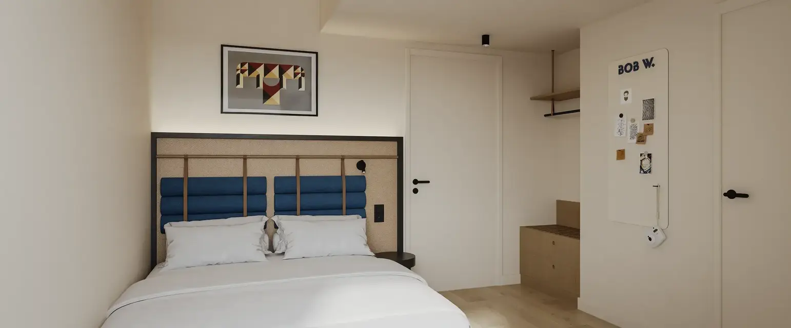 a bedroom with a bed and a picture on the wall