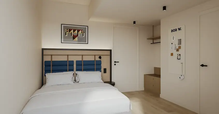 a bedroom with a bed and a picture on the wall
