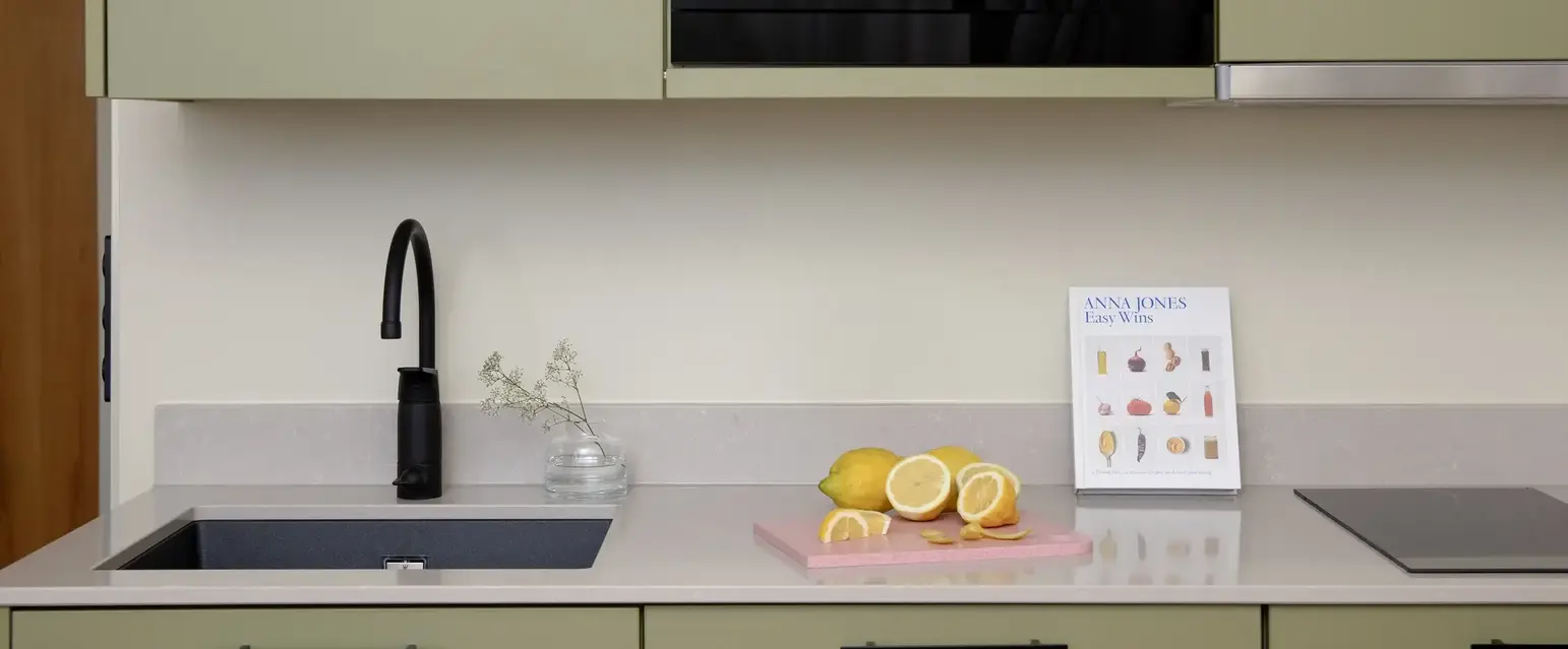 a kitchen with a microwave and a black sink