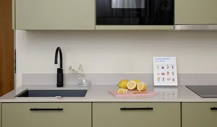 a kitchen with a microwave and a black sink