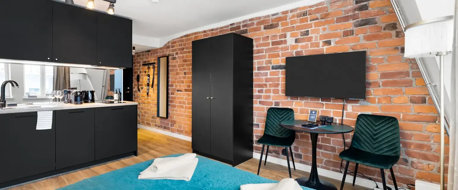 a room with a bed and a table and chairs