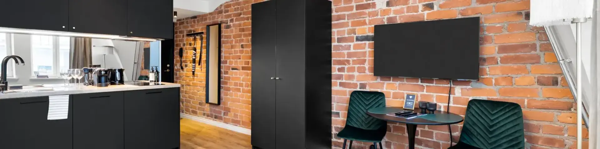 a room with a bed and a table and chairs