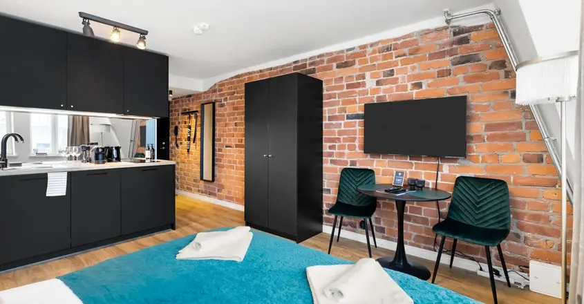 a room with a bed and a table and chairs