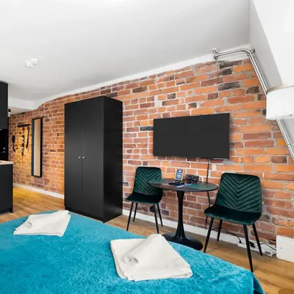 a room with a bed and a table and chairs