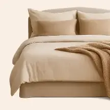 a bed with pillows and a blanket