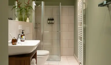 a bathroom with a glass shower door and sink