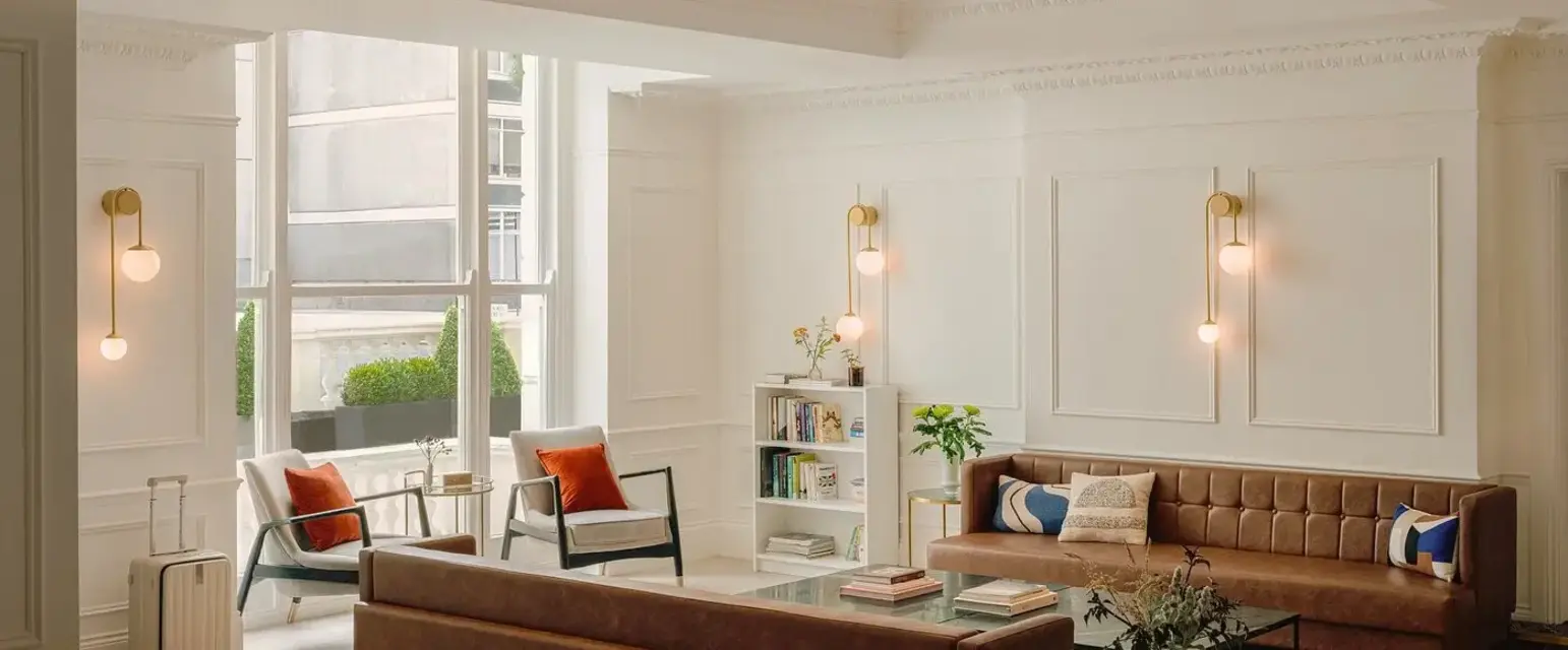 a room with a couch and chairs