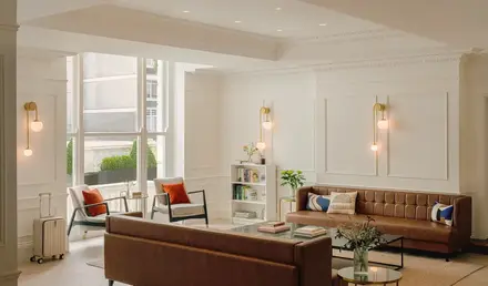 a room with a couch and chairs