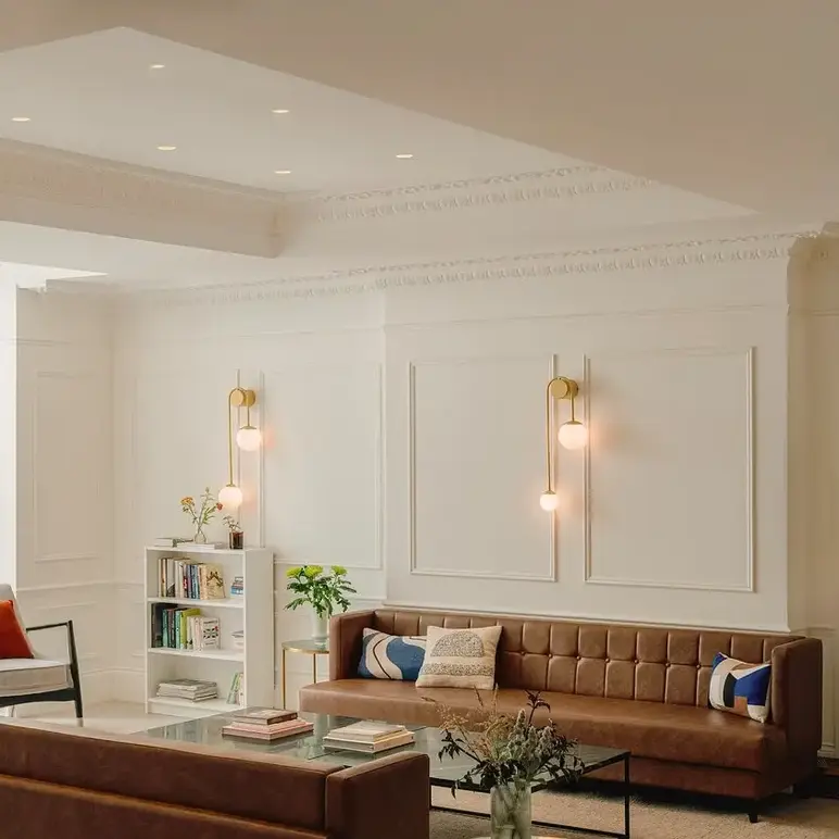 a room with a couch and chairs