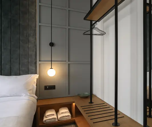 a room with a mirror and a shelf