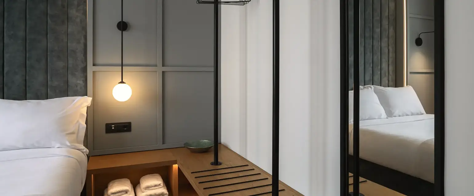 a room with a mirror and a shelf