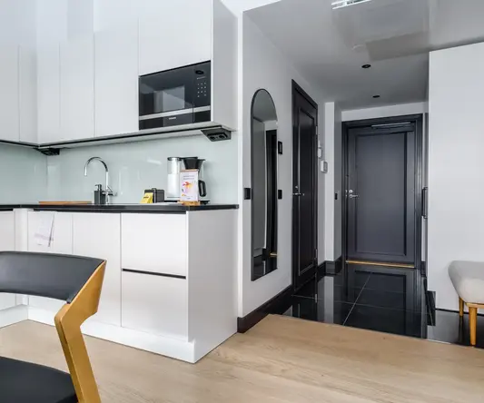 a kitchen with a black tile floor