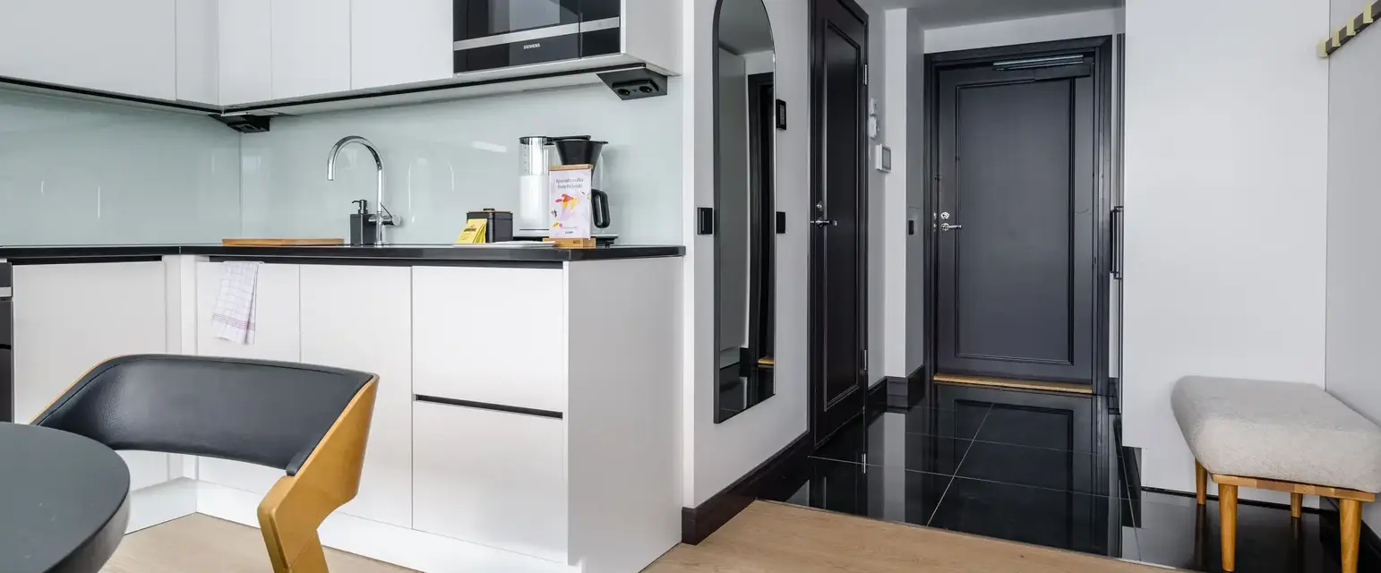 a kitchen with a black tile floor