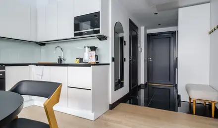 a kitchen with a black tile floor